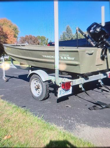 Tracker Topper 1036 Riveted Jon 2017 Tracker Topper 1036 Riveted Jon boat on trailer, parked outdoors.
