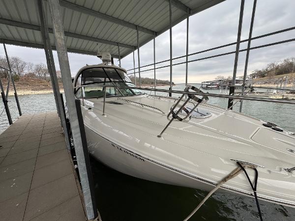 Sea Ray 330 Sundancer 2008 Sea Ray 330 Sundancer docked under a covered marina on a cloudy day.