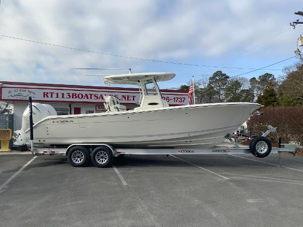 Cobia 285 Open Center Console 2025 Cobia 285 Open Center Console boat on trailer at dealership.