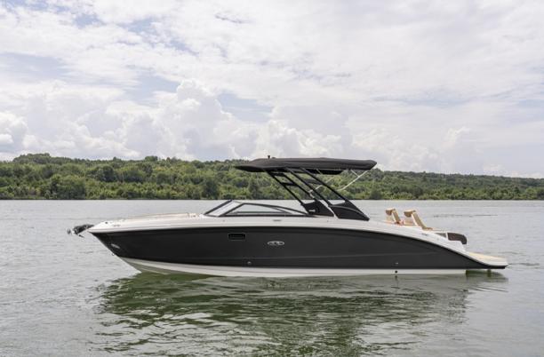 Sea Ray SDX 290 2026 Sea Ray SDX 290 boat on calm water with lush green shoreline.