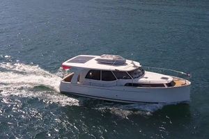 Greenline 33 2019 Greenline 33 yacht cruising on open water, showcasing sleek design and solar panels.