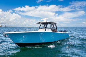 Sportsman Open 322 Center Console 2023 Sportsman Open 322 Center Console boat cruising on open water under a clear sky.