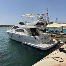 Astondoa 43 Fly 2016 Astondoa 43 Fly yacht docked at marina, sunny day, clear water.