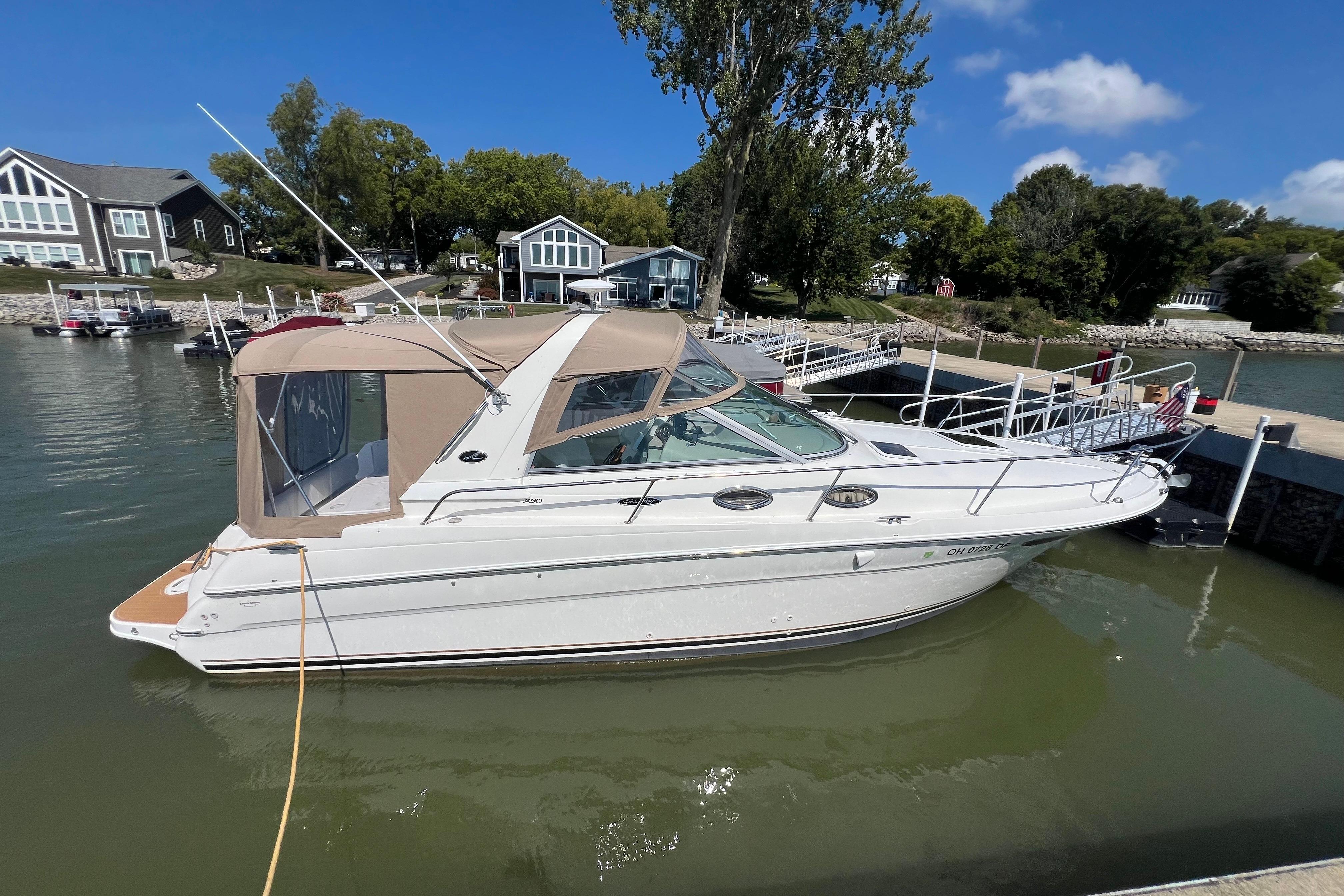 Sea Ray 290 Sundancer 2001 Sea Ray 290 Sundancer docked at a marina, surrounded by waterfront homes.