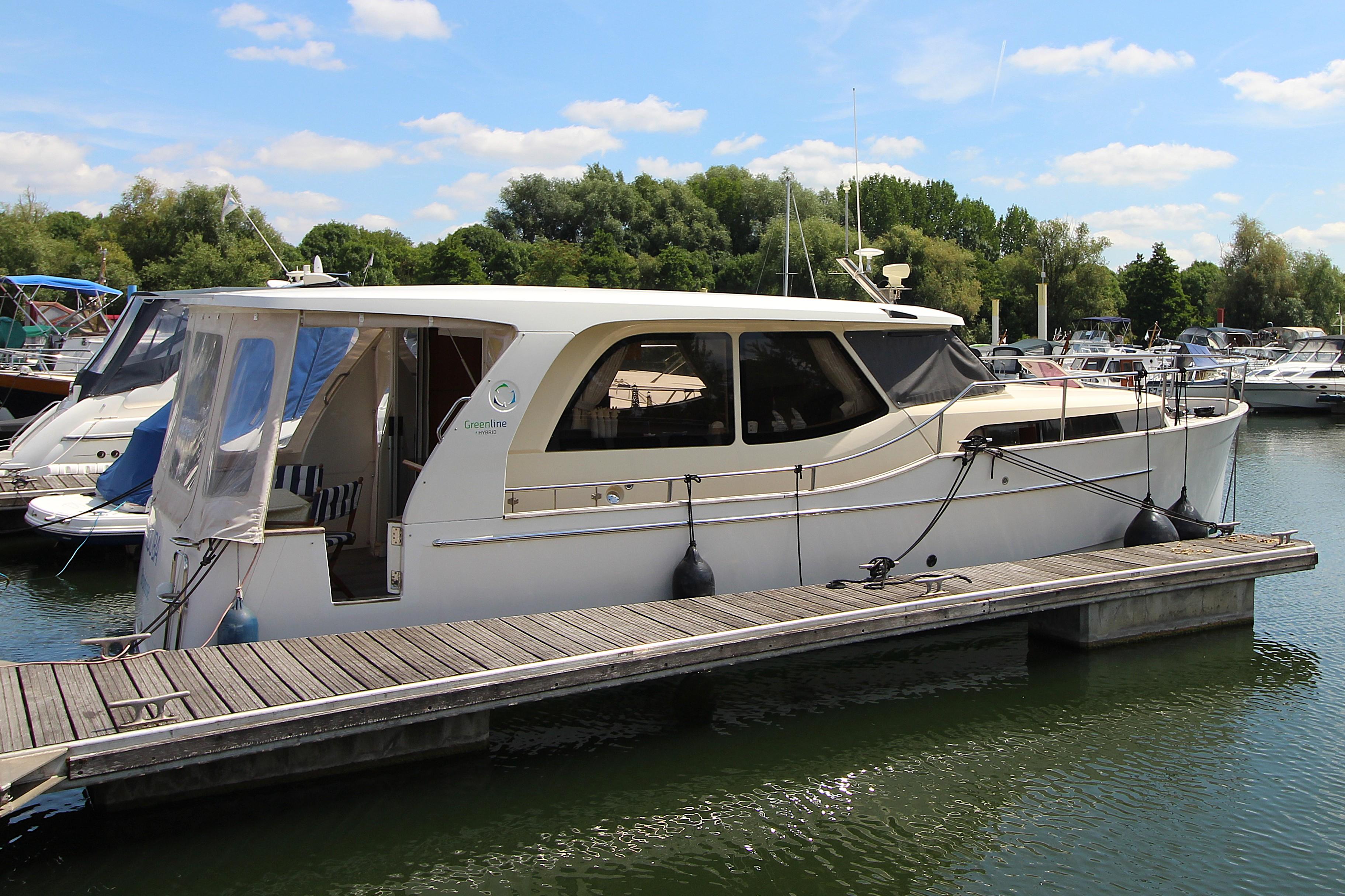 Greenline 33 2010 Greenline 33 yacht docked at a marina under a clear blue sky.