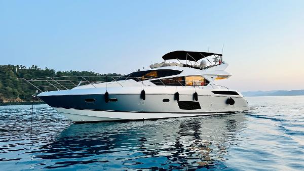 Sunseeker Manhattan 63 2012 Sunseeker Manhattan 63 yacht cruising on calm waters at sunset.