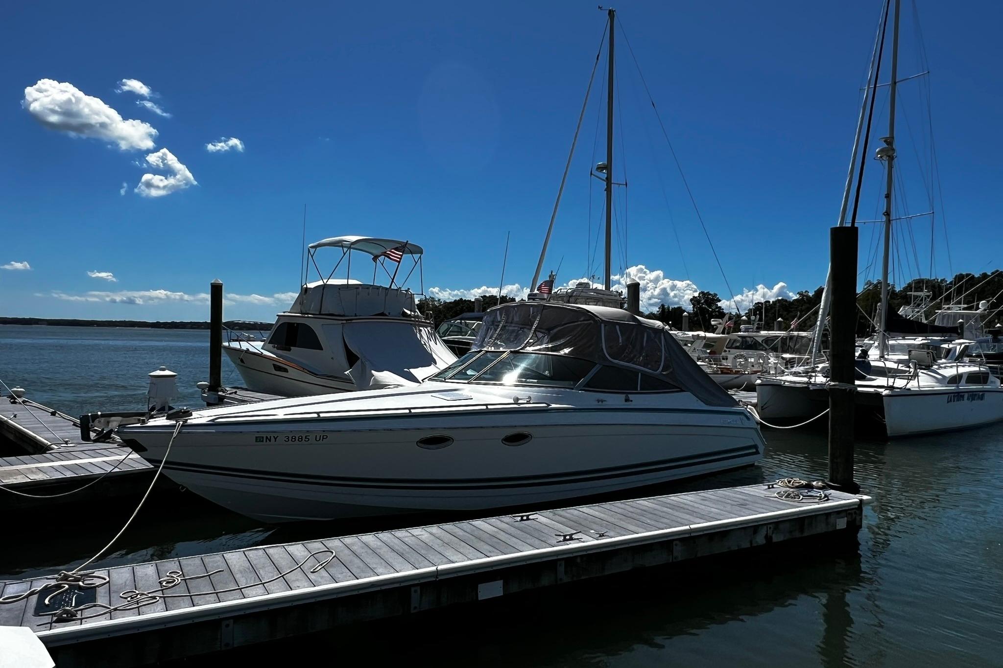 Formula 330 Sun Sport 1997 Formula 330 Sun Sport boat docked at marina under clear blue sky.