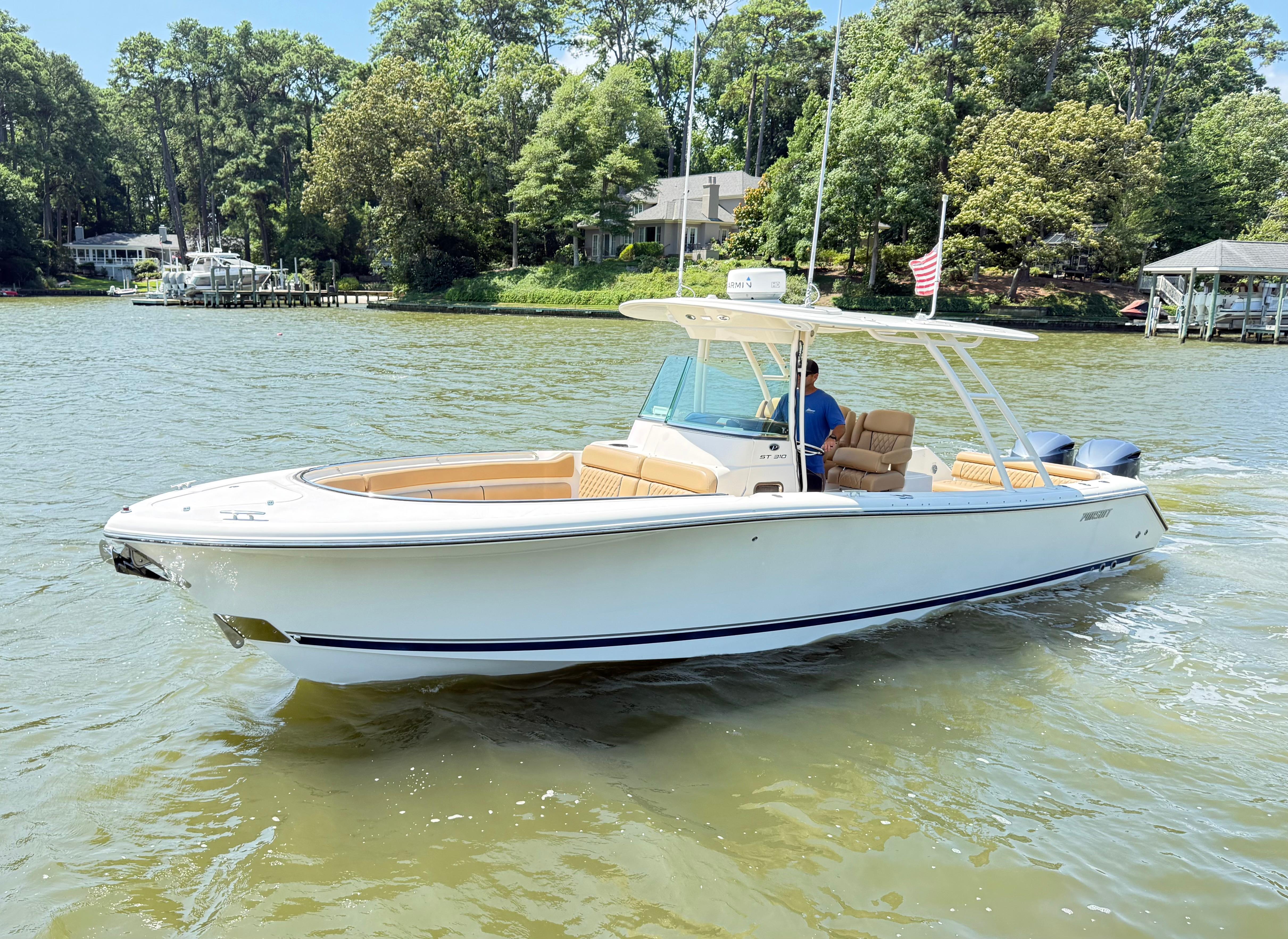 Pursuit ST 310 Sport 2014 Pursuit ST 310 Sport boat cruising on a scenic river.