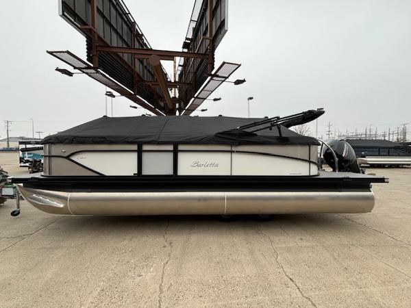 Barletta Cabrio 22 QC 2025 Barletta Cabrio 22 QC pontoon boat with cover, parked outdoors.
