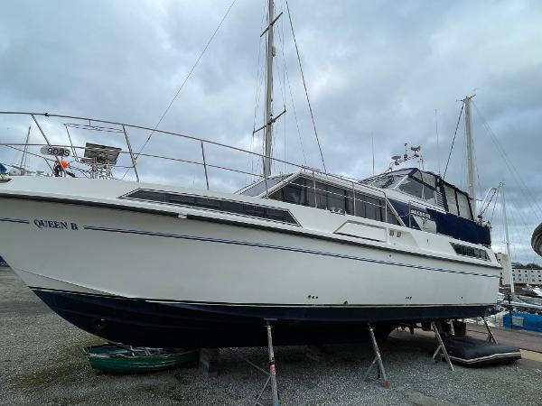 Broom Ocean 42 1984 Broom Ocean 42 yacht on dry dock, white hull, overcast sky.