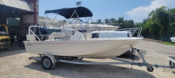 Boston Whaler 170 Montauk 2021 Boston Whaler 170 Montauk boat on trailer with canopy in outdoor setting.