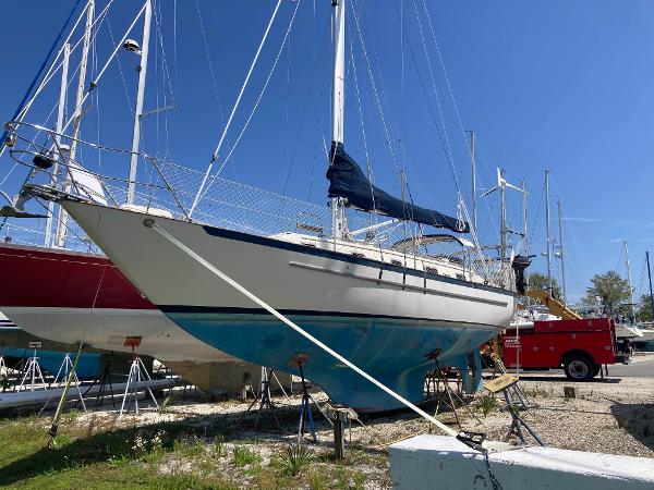 Pacific Seacraft 37 1994 Pacific Seacraft 37 Scheel Keel sailboat on dry dock, blue hull, sunny day.