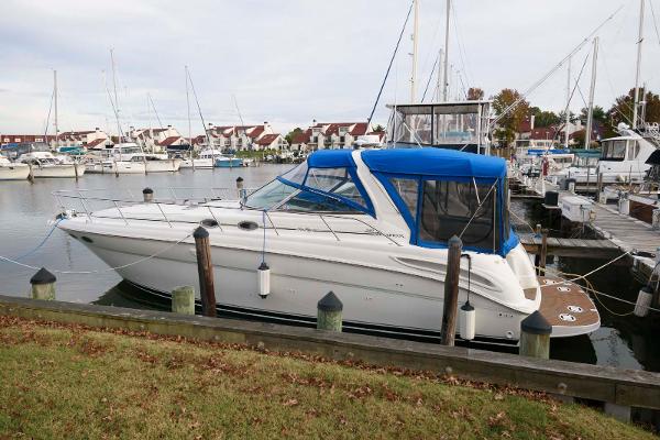 Sea Ray 380 Sundancer 2000 Sea Ray 380 Sundancer docked in a marina with blue canopy.