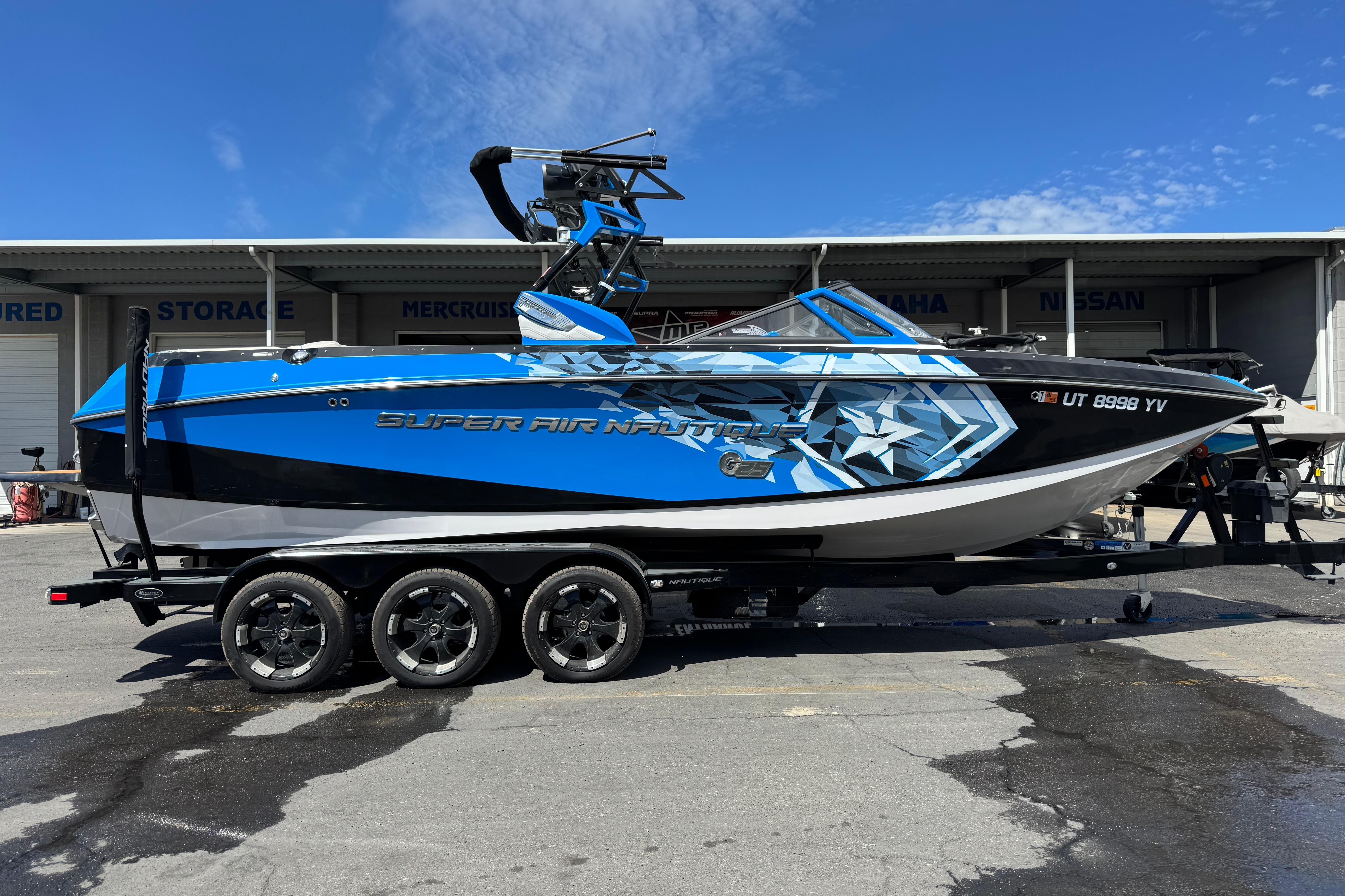 Nautique Super Air Nautique G25 2015 Nautique Super Air Nautique G25 boat in blue and black on a trailer.