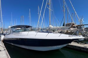 Larson Cabrio 370 2005 Larson-Cabrio 370 boat docked at marina under clear blue sky.