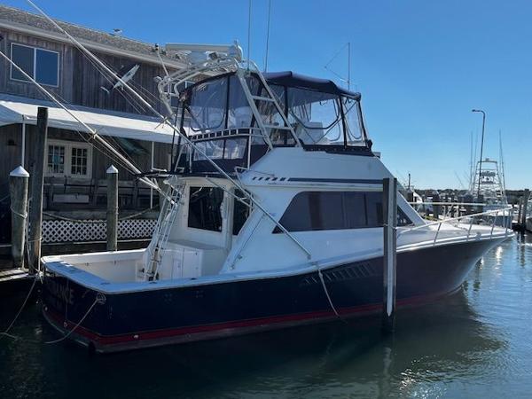 Viking 43 Convertible Must Sell NOW ! 1995 Viking 43 Convertible yacht docked at marina, featuring flybridge and sleek design.