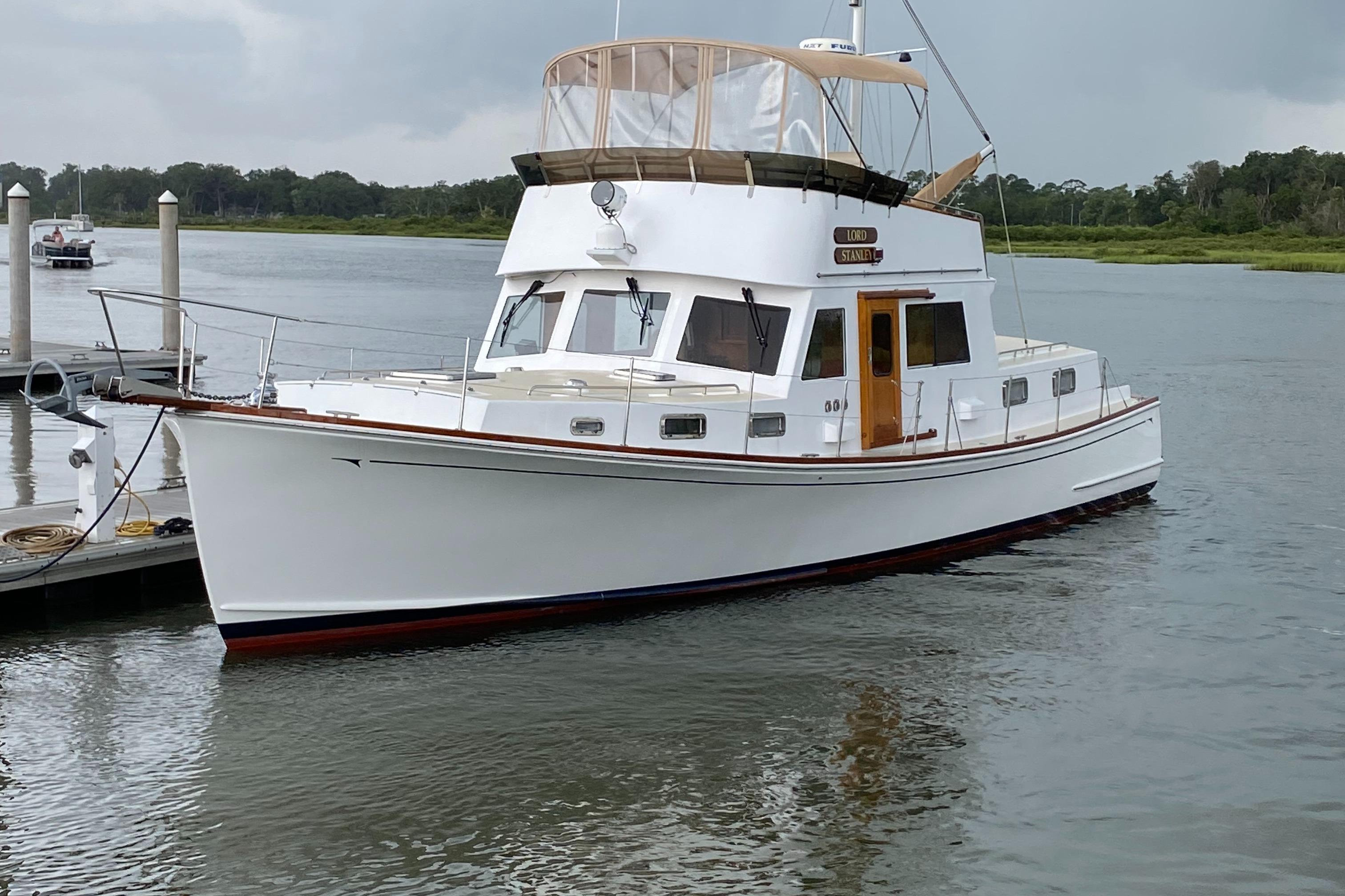 Jarvis Newman Lobster Style Cruiser With Aft Cabin 1988 Jarvis Newman Lobster Style Cruiser with aft cabin docked on calm water.