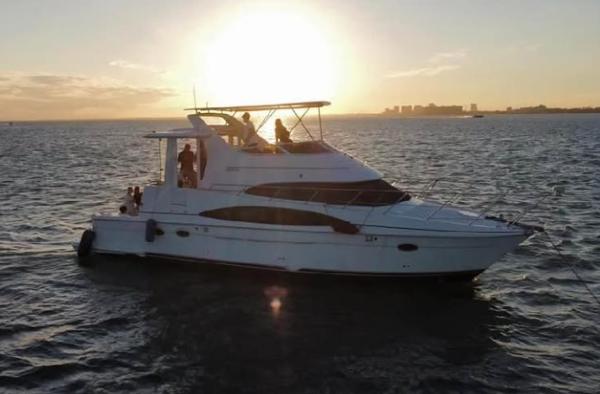 Carver 444 Cockpit Motor Yacht 2004 Carver 444 Cockpit Motor Yacht at sunset on open water.