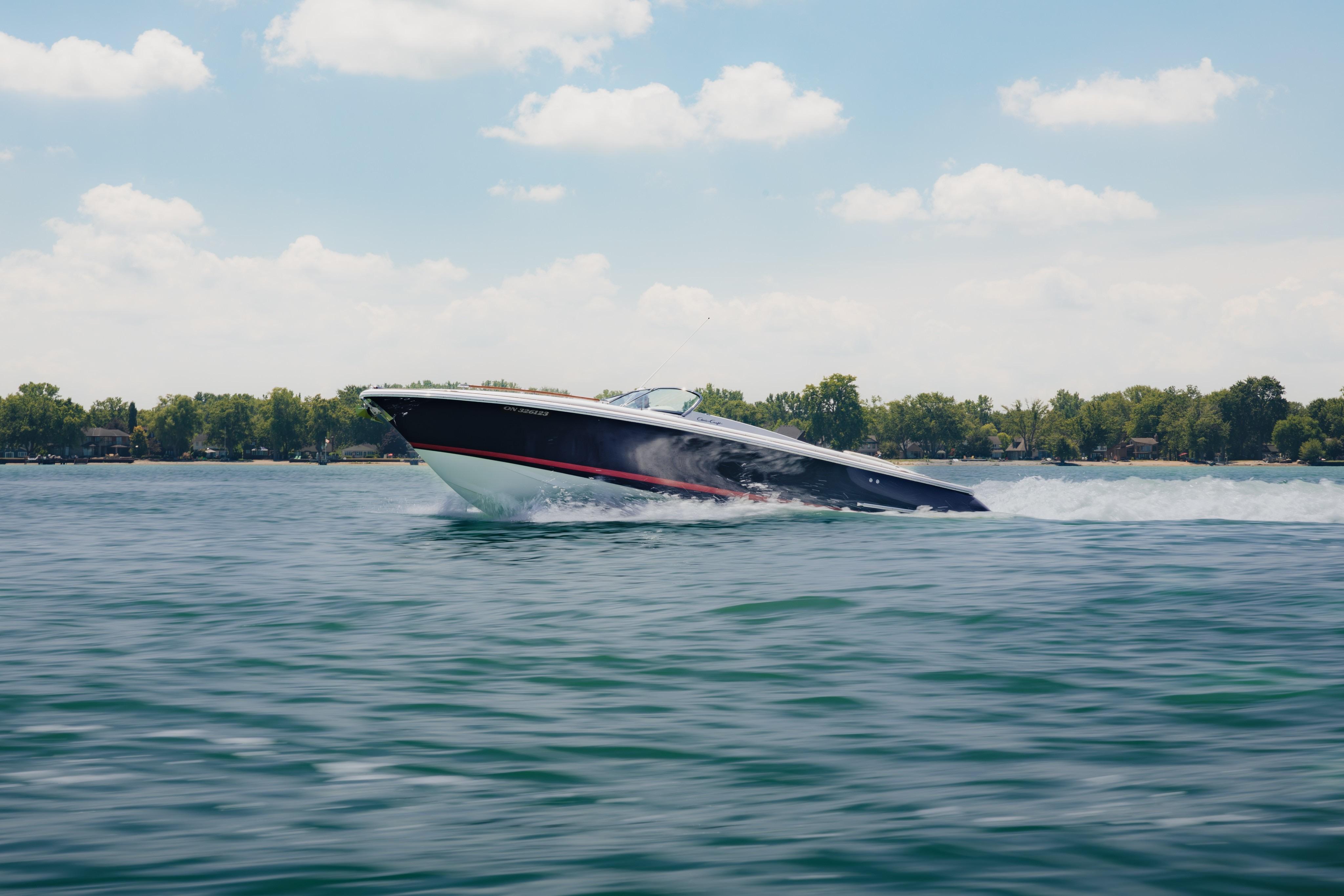 Chris-Craft Corsair 28 2006 Chris-Craft Corsair 28 speedboat cruising on a sunny lake.