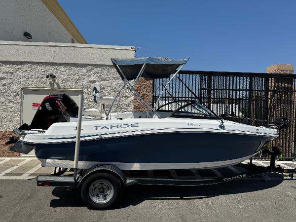 Tracker Tahoe 450 TF 2021 Tracker Tahoe 450 TF boat on trailer, parked outdoors.