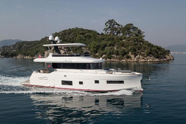 Sirena 58 2018 Sirena 58 yacht cruising near a lush, tree-covered island.