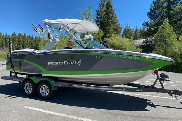 MasterCraft X23 2017 MasterCraft X23 boat on trailer in scenic outdoor setting.