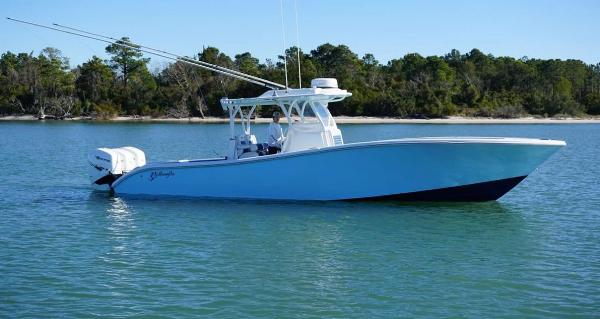 Yellowfin 34 2019 Yellowfin 34 boat on calm water with forested shoreline.