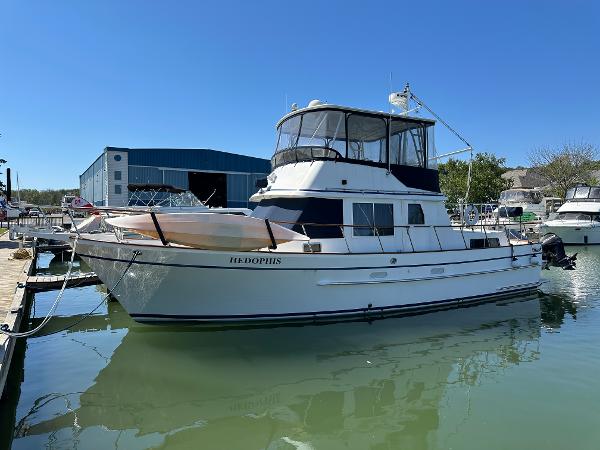 Monk 42 1989 Monk 42 yacht docked at marina under clear blue sky.