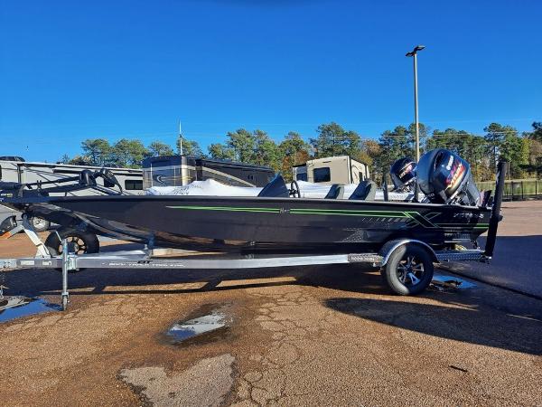 Xpress H20C Crappie 2025 Xpress H20C Crappie boat on trailer, parked outdoors under clear blue sky.