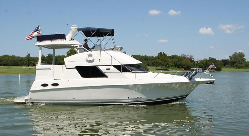 Silverton 392 Motor Yacht 1999 Silverton 392 Motor Yacht cruising on a lake under a clear blue sky.