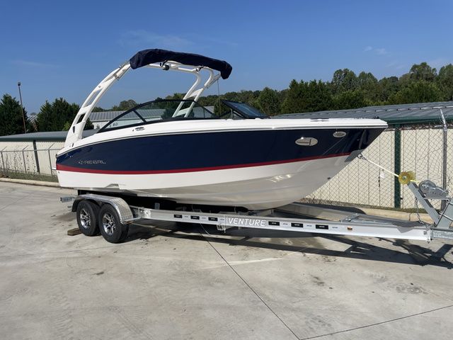 Regal LS2 2026 Regal LS2 boat on trailer, parked outdoors, under clear blue sky.