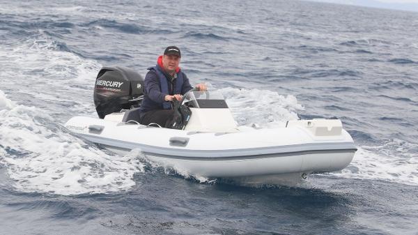 Northstar Axis 3.4 Man driving 2021 Northstar Axis 3.4 inflatable boat on open water.