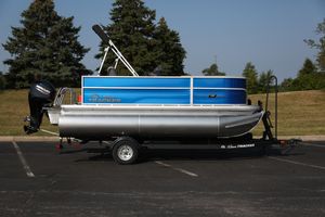 Sun Tracker Party Barge 16 DLX 2026 Sun Tracker Party Barge 16 DLX pontoon boat on trailer, parked outdoors.