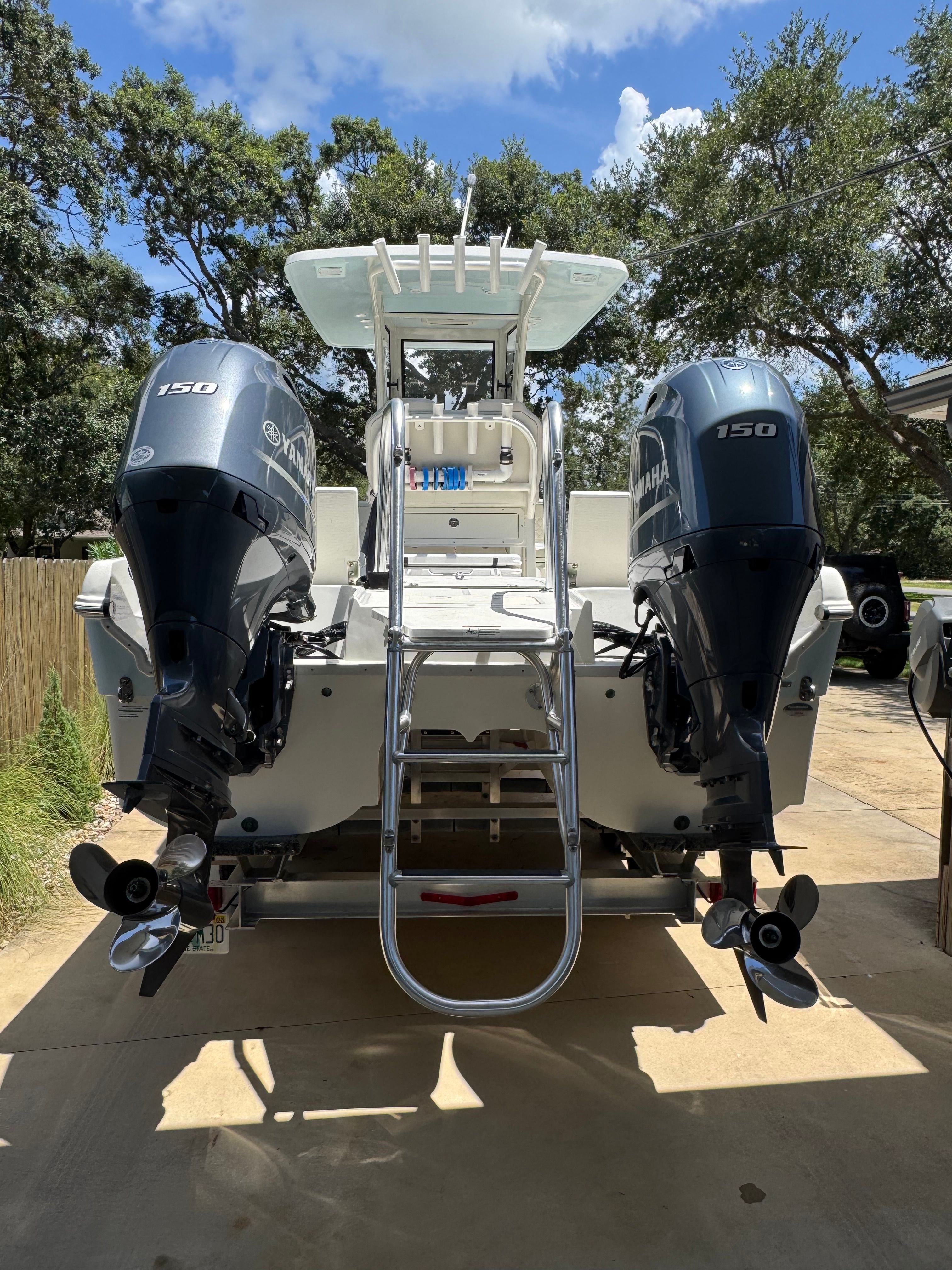 World Cat 235 CC 2024 World Cat 235 CC boat with dual Yamaha 150 engines, rear view.