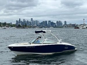 Cobalt CS23 Surf 2020 Cobalt CS23 Surf boat on water with city skyline in background.