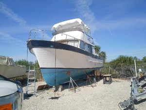 Marine Trader Double Cabin 1975 Marine Trader 40 Double Cabin boat on dry dock under clear blue sky.