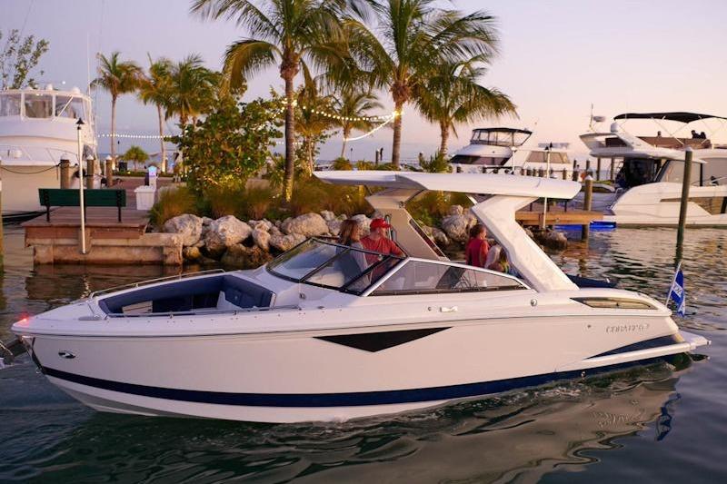 Cobalt A29 2026 Cobalt A29 boat docked near palm trees at sunset.