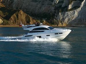 Fairline Squadron 48 2016 Fairline Squadron 48 yacht cruising near rocky coastline.