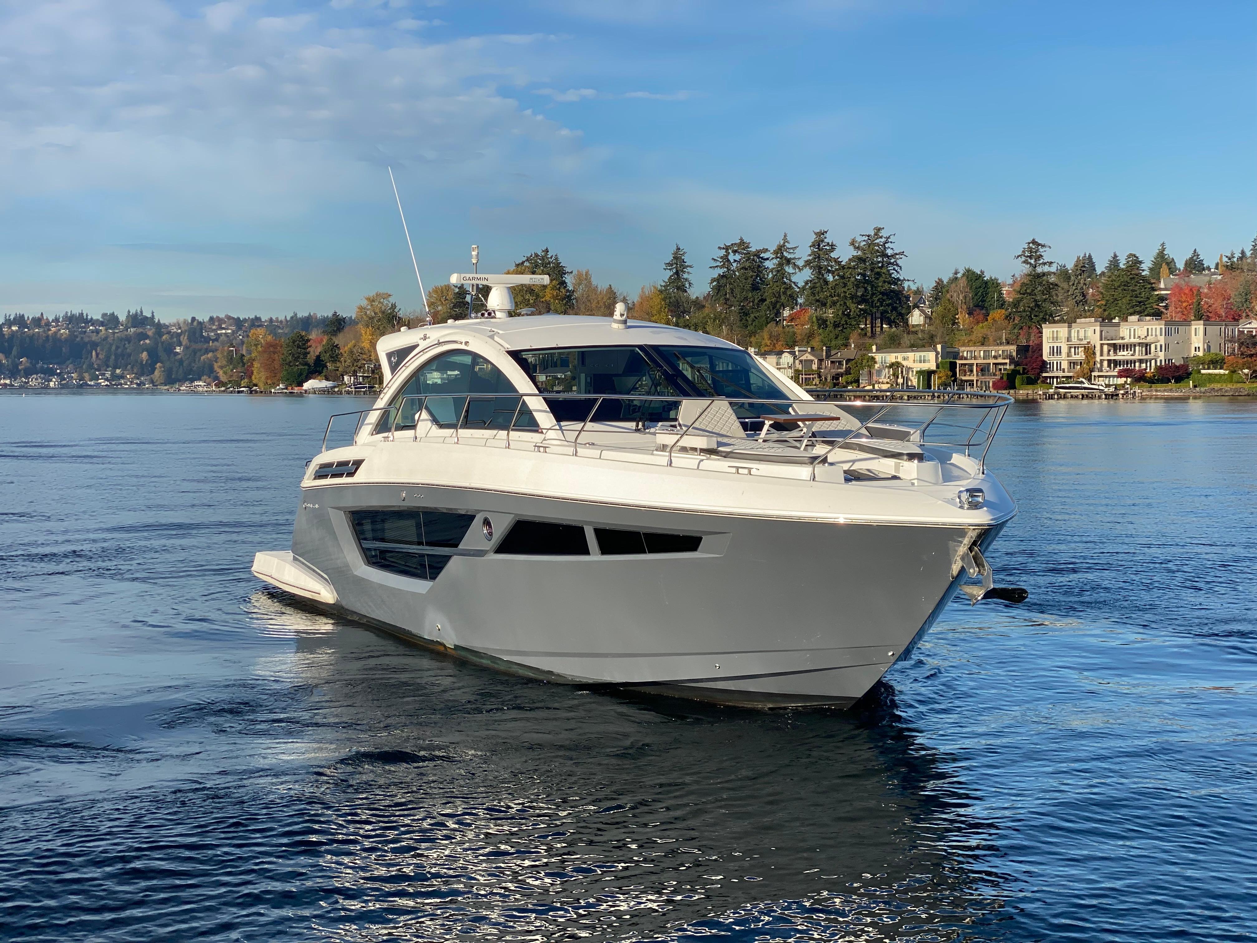 Cruisers Yachts Cantius 2018 Cruisers Yachts Cantius on serene lake with scenic backdrop.