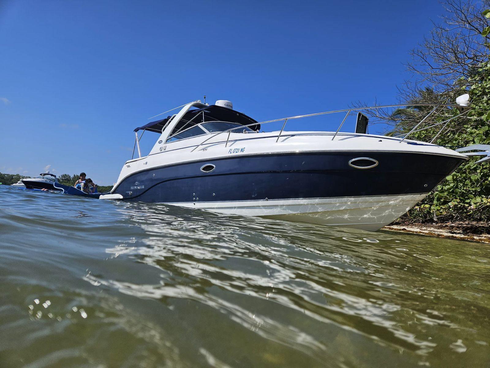 Rinker 300 Express Cruiser 2006 Rinker 300 Express Cruiser anchored near shore on a sunny day.