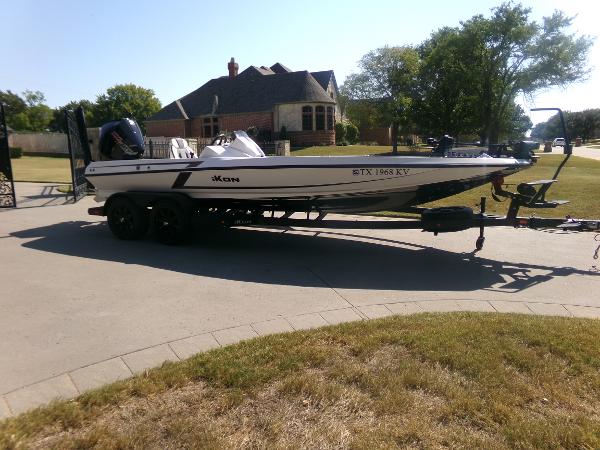 iKon LX21 2024 iKon LX21 boat on trailer in suburban driveway.