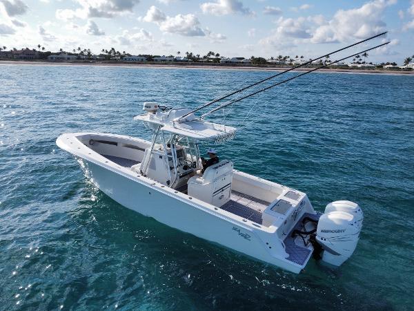 SeaVee 340Z 2017 SeaVee 340Z boat on clear ocean water, equipped with fishing rods and Mercury engines.