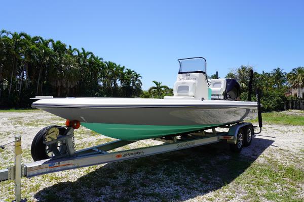 ShearWater X22 2024 ShearWater X22 boat on trailer, parked outdoors with palm trees in background.