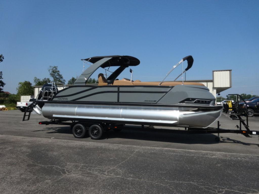 Harris Grand Mariner 250 2026 Harris Grand Mariner 250 pontoon boat on trailer, parked outdoors.