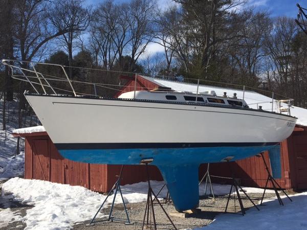 S2 9.1 1985 S2 9.1 sailboat on stands in a snowy yard.