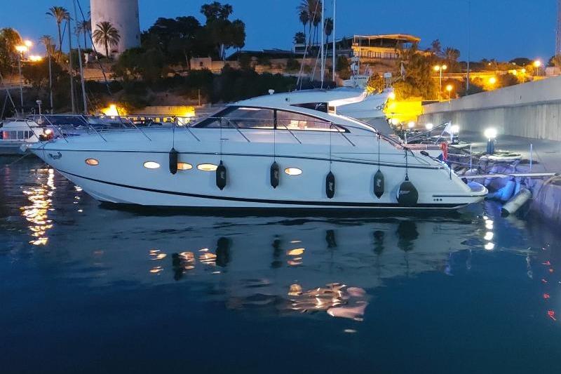 Princess V45 2007 Princess V45 yacht docked at night, illuminated by marina lights.