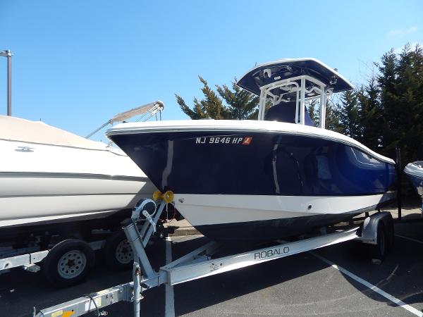 Robalo R230 Center Console 2021 Robalo R230 Center Console boat on trailer, parked outdoors.