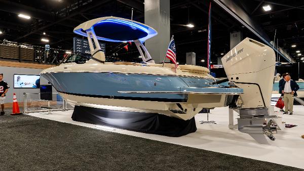 Chris-Craft Sportster 28 2025 Chris-Craft Sportster 28 boat displayed indoors with blue lighting and American flag.