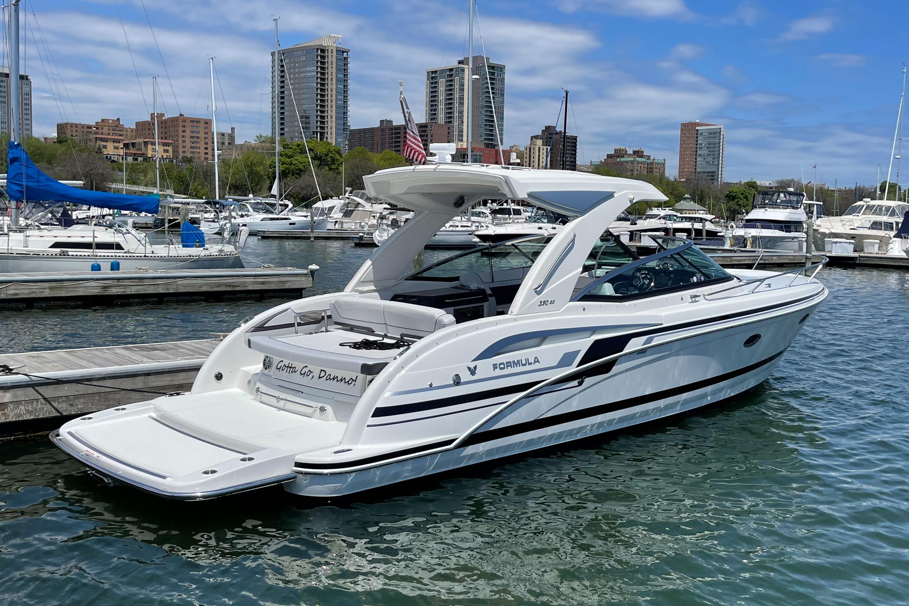 Formula 350 Sun Sport 2020 Formula 350 Sun Sport boat docked in a marina with city skyline.