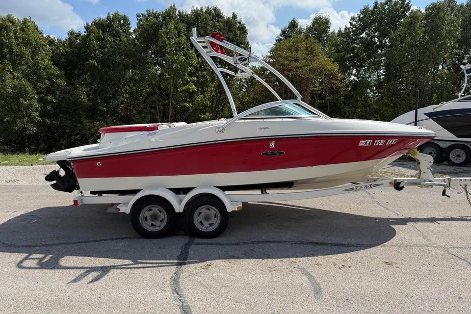 Sea Ray 195 Sport 2006 Sea Ray 195 Sport boat on trailer, red and white, parked outdoors.